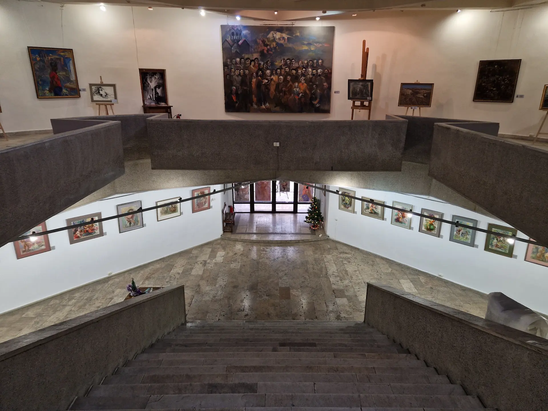 Vue des deux étages du musée d'Eduard Isabekyan. Il y a de plus petits tableaux au premier étage et de plus grandes fresques au second étage.